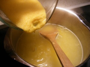 adding corn meal to pot of water