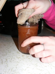 wiping rim of mason jar