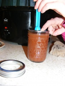 placing hot lid on mason jar