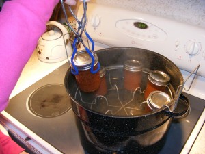lifting hot mason jars from boiling bath